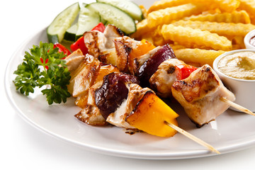 Grilled meat, French fries and vegetables 
