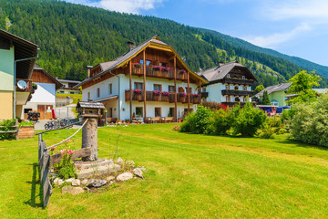 Traditional alpine houses in small village on shore of Weissensee lake, Austria