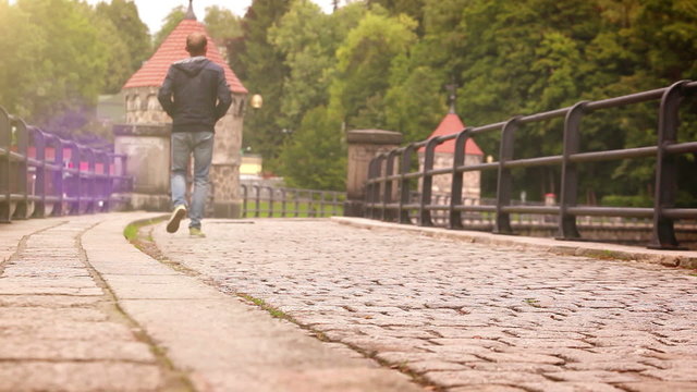 Old dam in Liberec (Czech Republic) with people promenading by its cobbles