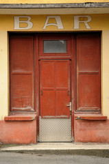 Old red wooden door at public bar