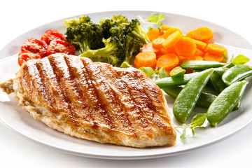 Roast chicken fillet and vegetables on white background 