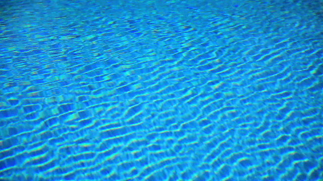 Background. Swimming pool water surface ripples & sunlight reflections.