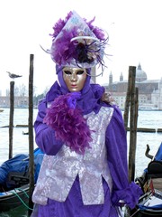 Naklejka na ściany i meble Elegant and mysterious woman in violet outfit at Carnival of Venice, Italy