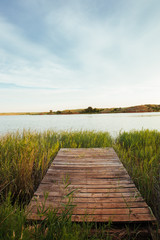 Small dock leading to serene lake 