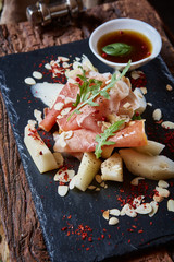 salad of fresh melon with thin slices prosciutto