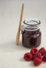  jam jar with raspberry jam and fresh raspberries
