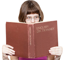 girl with glasses reads English Dictionary book