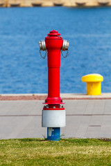 Red fire hydrant in the port.