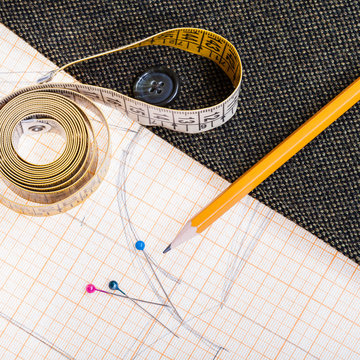 pattern, measuring tape, pencil, pins, tweed coat