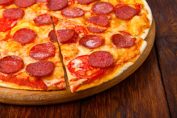 Delicious pizza with pepperoni and tomatoes