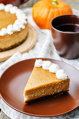 pumpkin cheesecake decorated with whipped cream