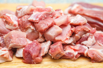 meat chopped into small pieces on a cutting board