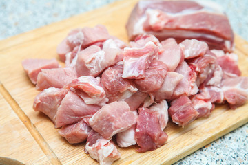 meat chopped into small pieces on a cutting board