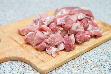 meat chopped into small pieces on a cutting board