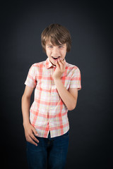 Handsome boy doing different expressions in different sets of clothes: toothache