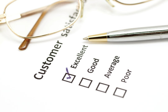customer satisfaction survey form with pen and eye glasses