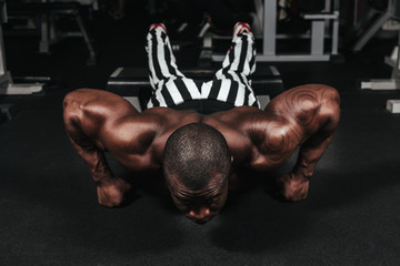 Weight training African doing bodybuilding