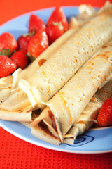 Pancakes with chocolate and strawberries