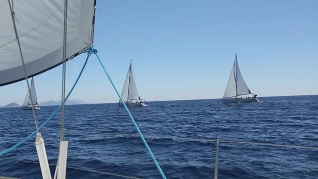 Ship yachts with white sails in the open sea. Sailing. Yachting. Tourism. Luxury Lifestyle. Luxury yachts. Boat in sailing regatta.