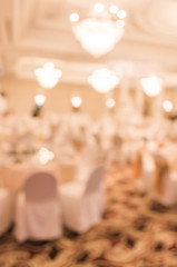 blurred image of Large dining table set for wedding, dinner or f