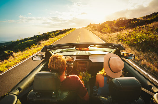 Happy Couple Driving In Convertible