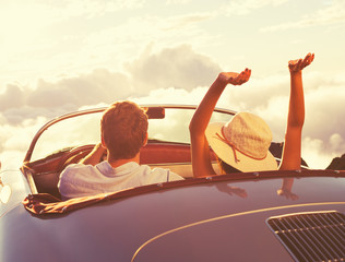 Young Couple Wathcing the Sunset in Vintage Sports Car