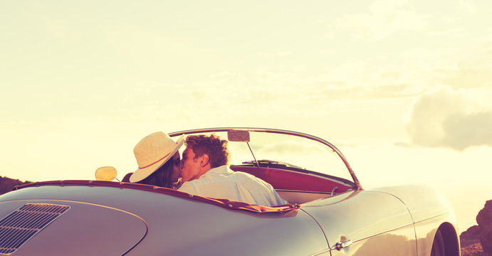 Couple Kissing in Classic Vintage Sports Car