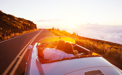 Romantic Couple Driving on Beautiful Road at Sunset