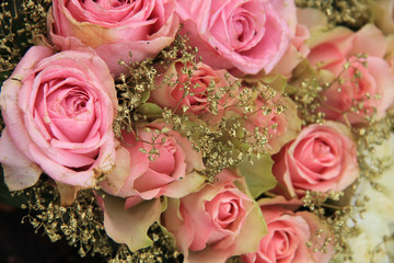 Mixed pink roses in bridal arrangement