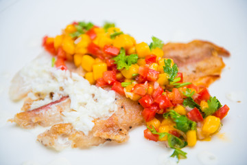 fish steak with mango sauce and tomatoes