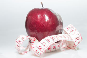 Red apple and tape measure
