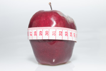 Red apple and tape measure