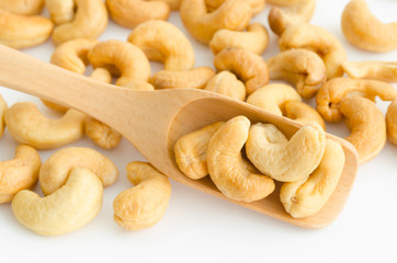 Cashew nuts in wooden spoon.