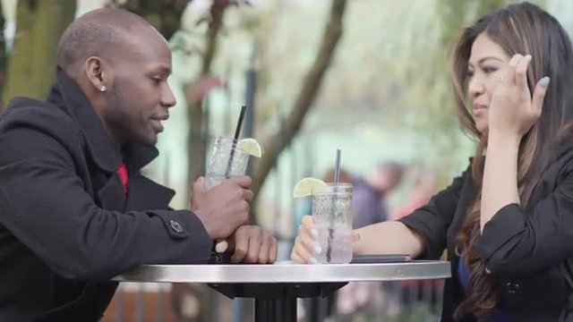 A couple on a date at an outdoor cafe