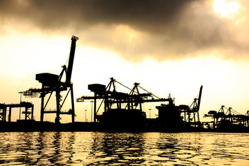 Fototapeta na wymiar Dramatic Scenery of the Shipyards near River.