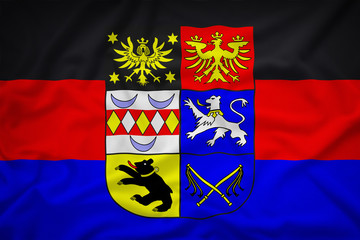 Ostfriesland mit Wappen flag on the fabric texture background,Vi
