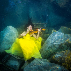 The girl with a violin under water