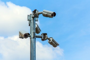 CCTV camera or Surveillance Operaiting on Blue Sky.