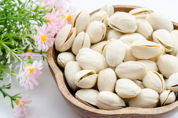 Pistachios nuts in a wooden bowl