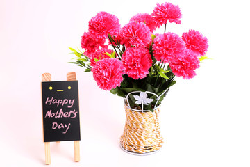 A Bouquet of Carnations and a Small Blackboard with Words “Happy Mother's Day”
