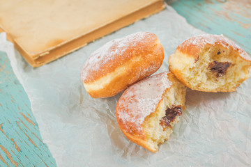 Sweet sugary donuts on rustic table