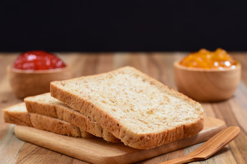 Fototapeta na wymiar slices bread with jam on wooden table