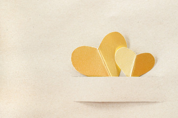 Gold heart on vintage brown paper.
