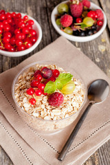 cereal and various berry for breakfast, close-up, vertical