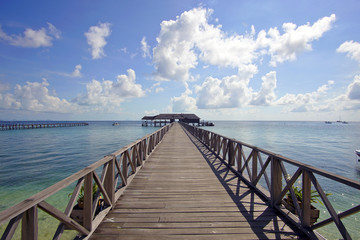 Fototapeta na wymiar endless jetty to the horizon; view to a turquoise sea and blue s