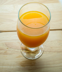 Full high glass of orange juice on background