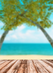 Fototapeta premium Blurred image of sea sky coconut tree with wooden under for put products.