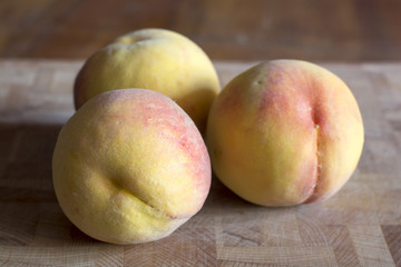  peaches on wood background