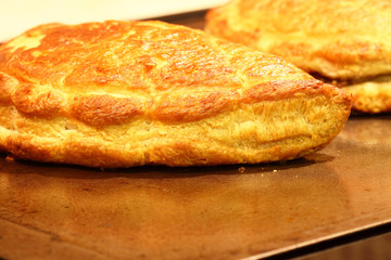 Cornish pasties.
Freshly baked Cornish pasties on a baking tray.