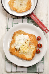 hungarian langos with sour cream and cheese
